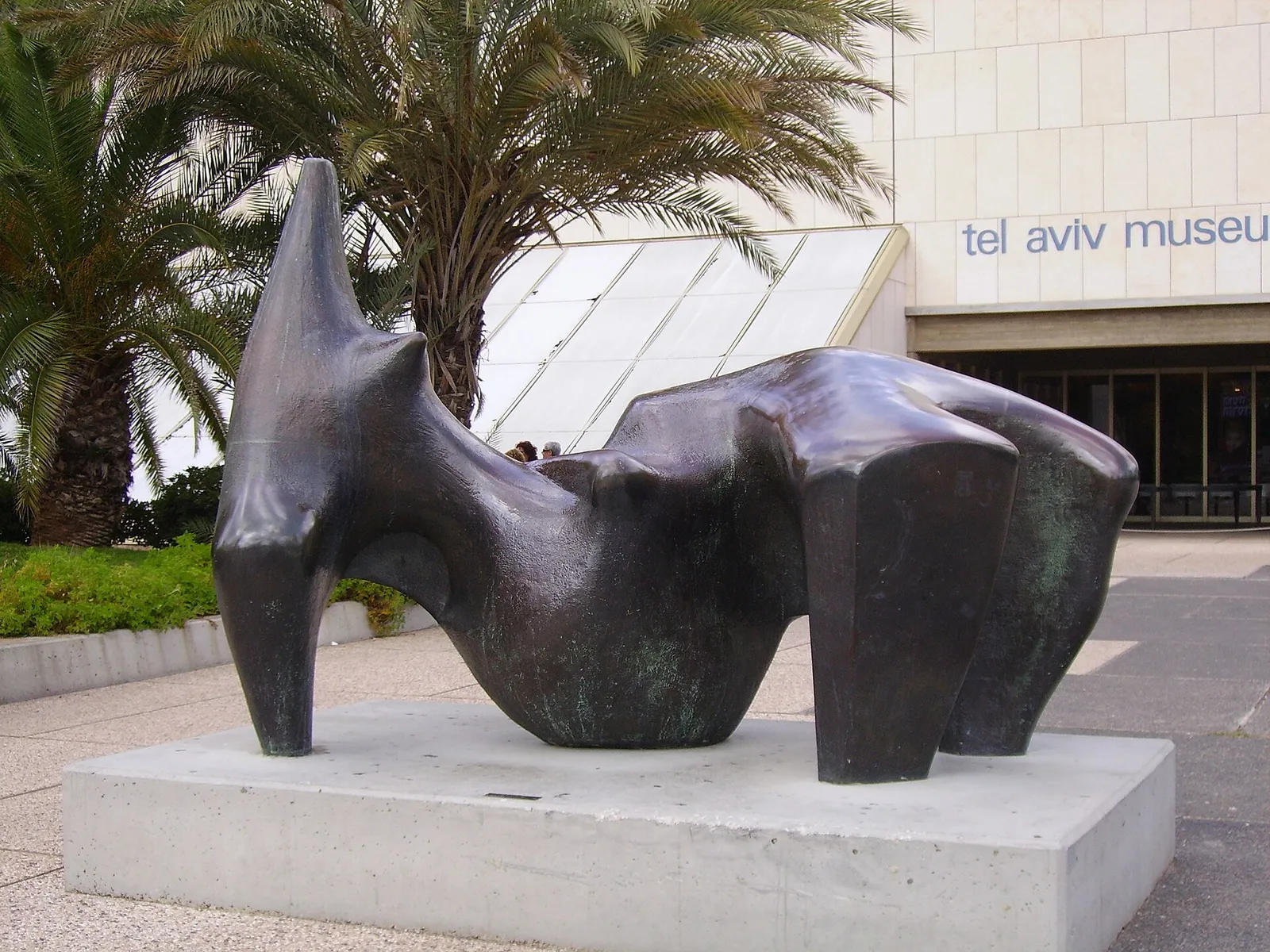A Henry Moore reclining figure sculpture displayed outdoors