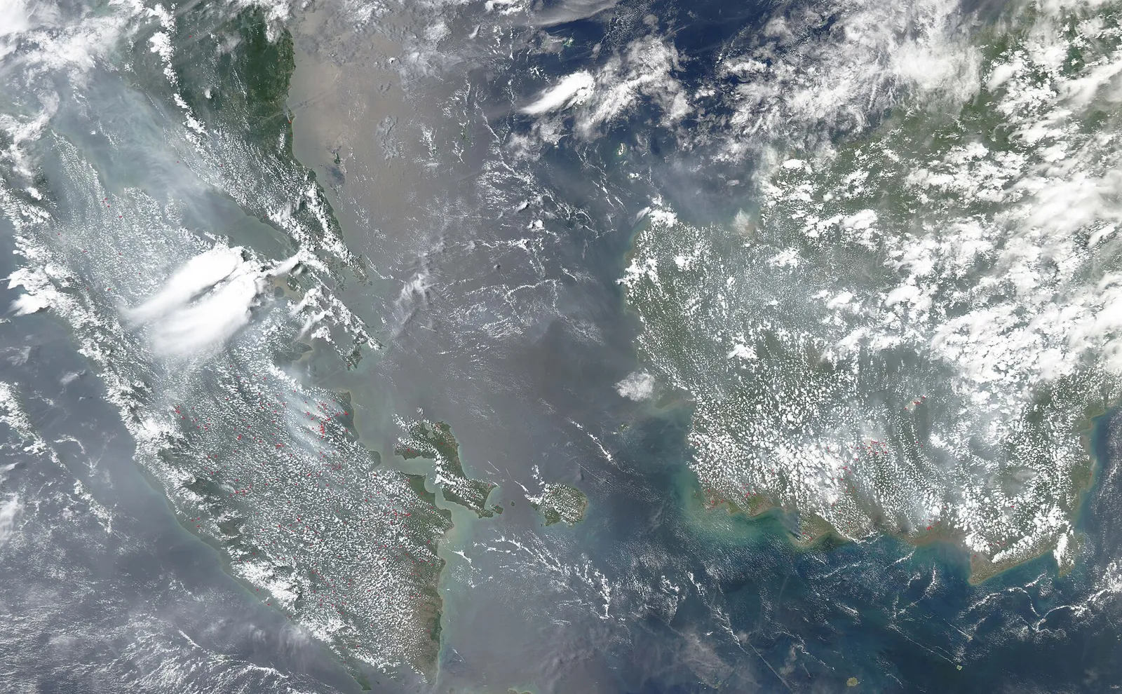 A satellite view of fires and smoke over Borneo and Sumatra