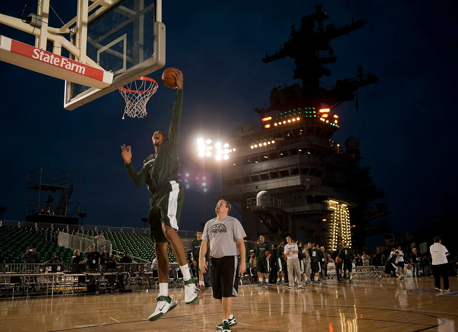A college basketball player dunks during a game