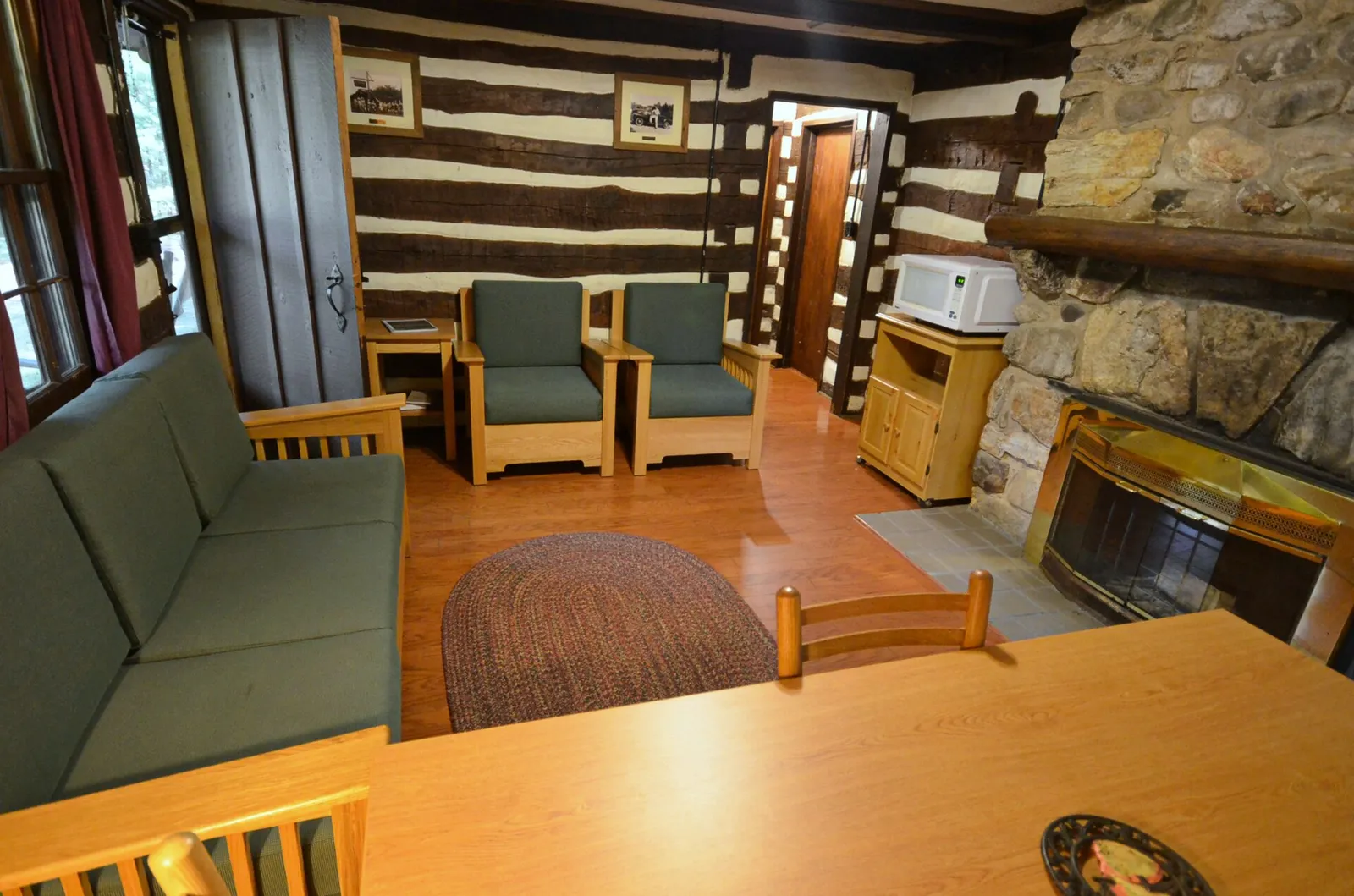 A living room with a sofa, lamps and a fireplace