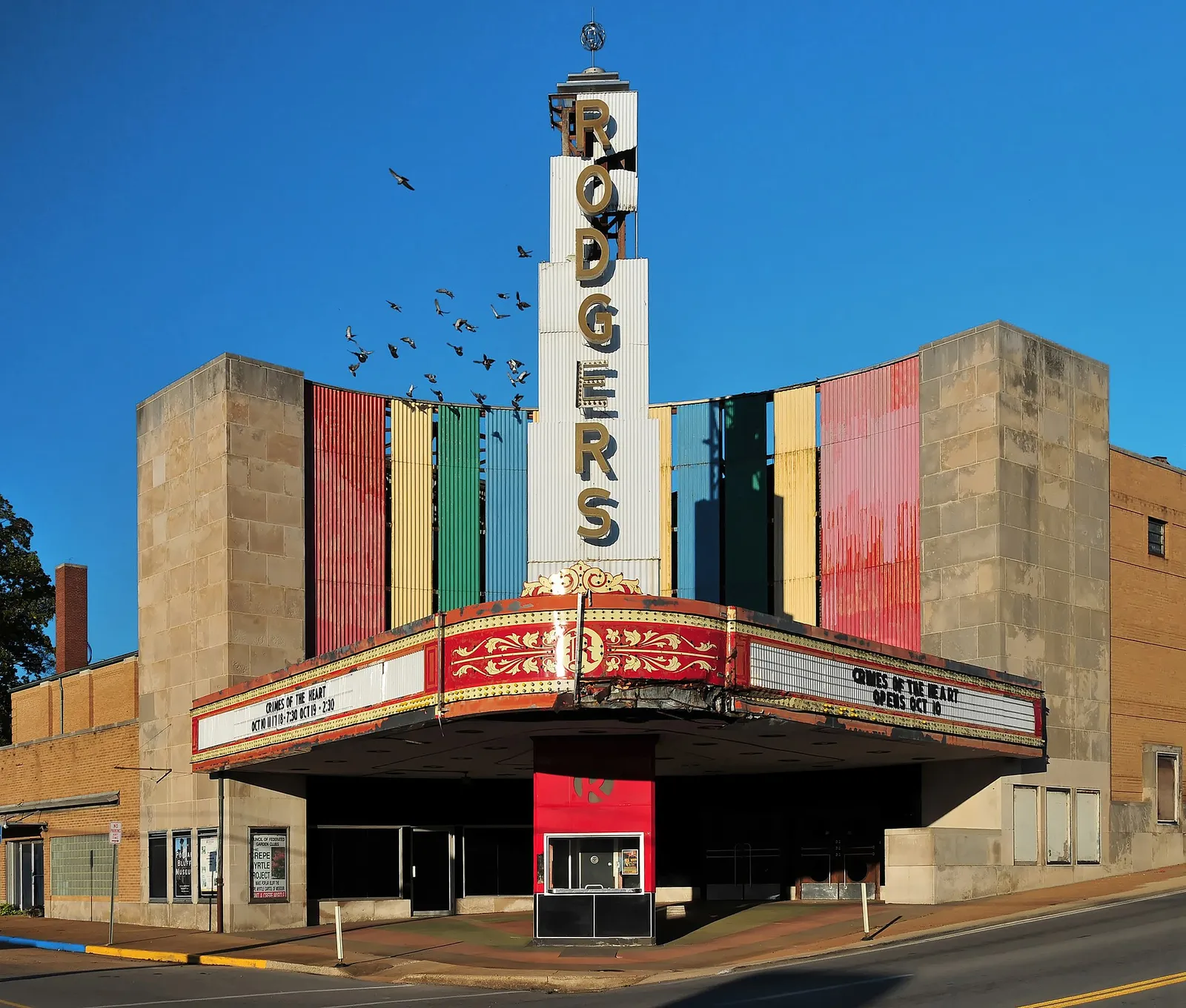 The illuminated marquee of a cinema at dusk