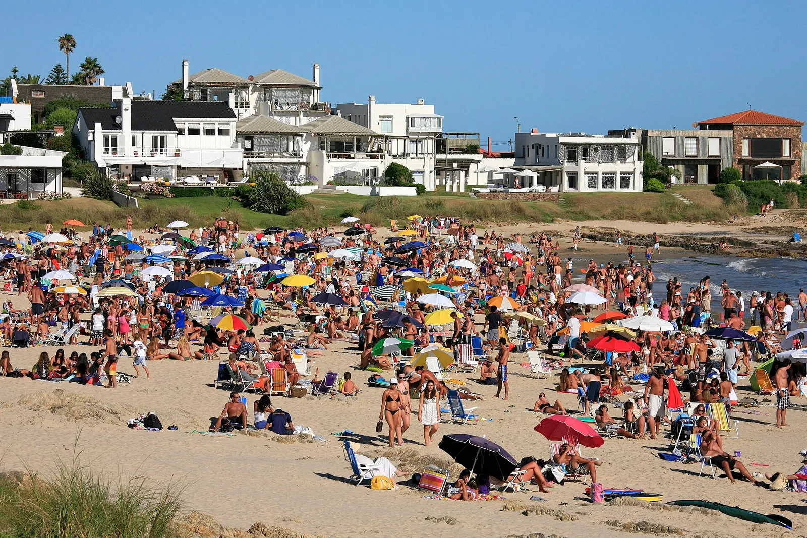 People at a crowded beach on a hot summer day (illustrative)