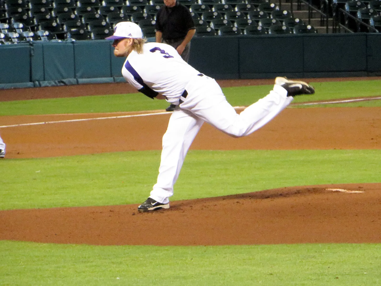 A baseball pitcher in mid-delivery