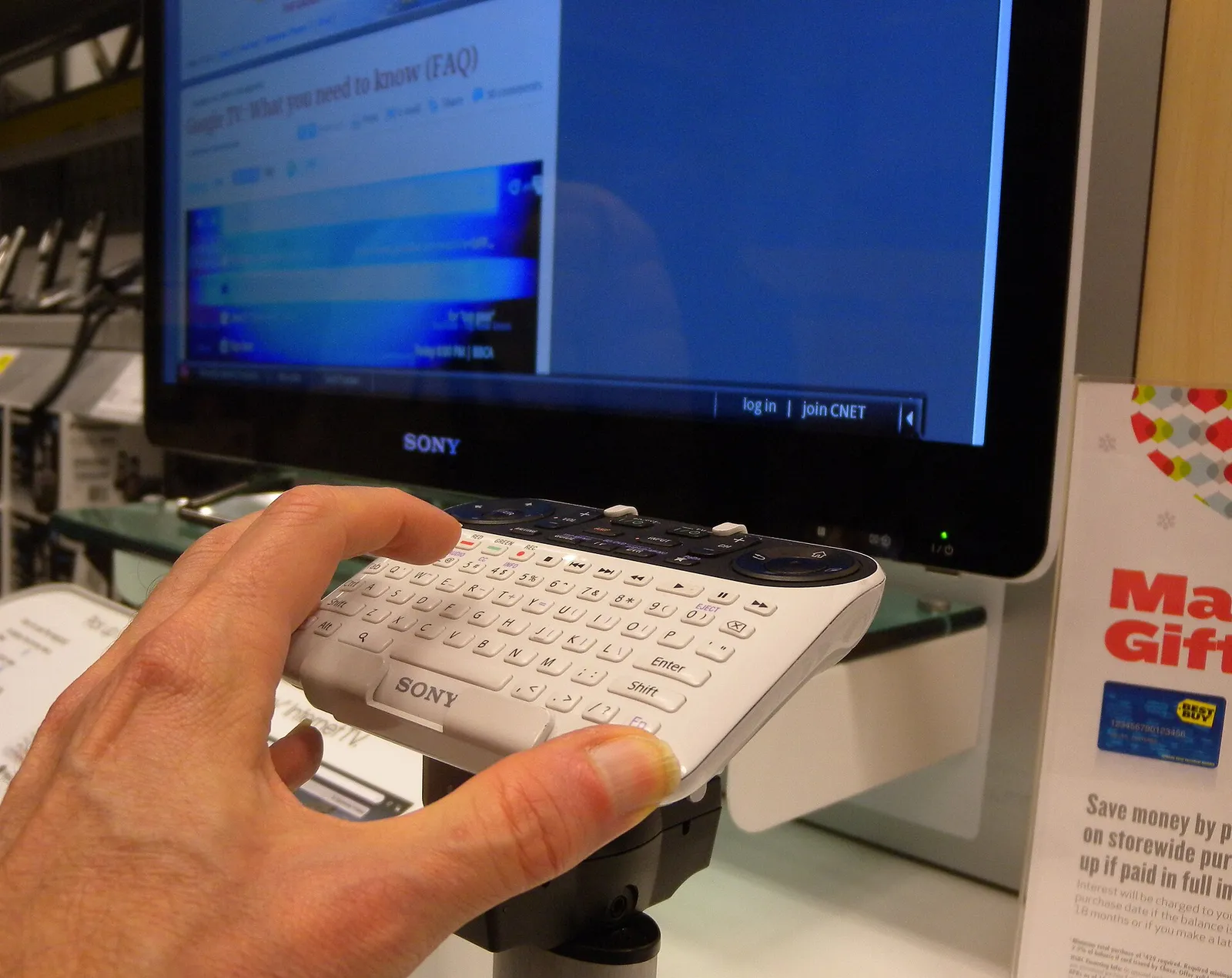 A hand using a smart-TV controller in front of a television (file image)