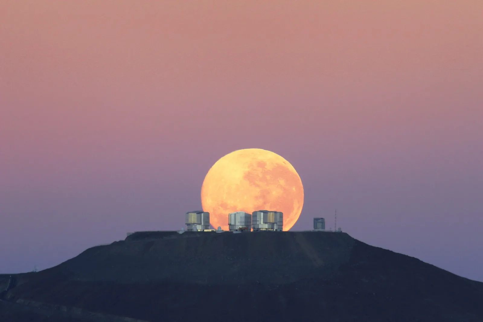 The moon setting over the European Southern Observatory's Very Large Telescope in Chile