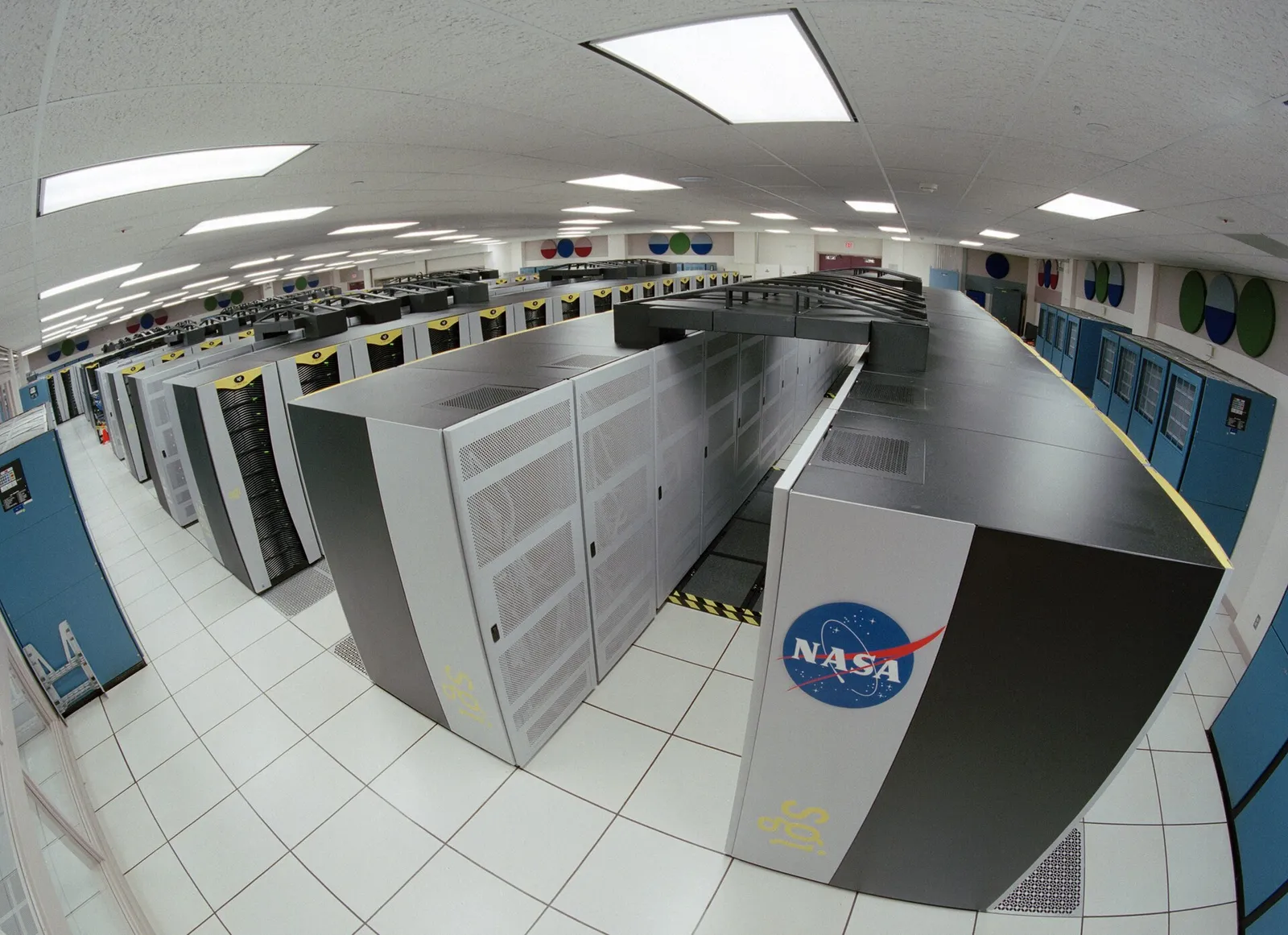 Rows of cabinets in a large supercomputing facility