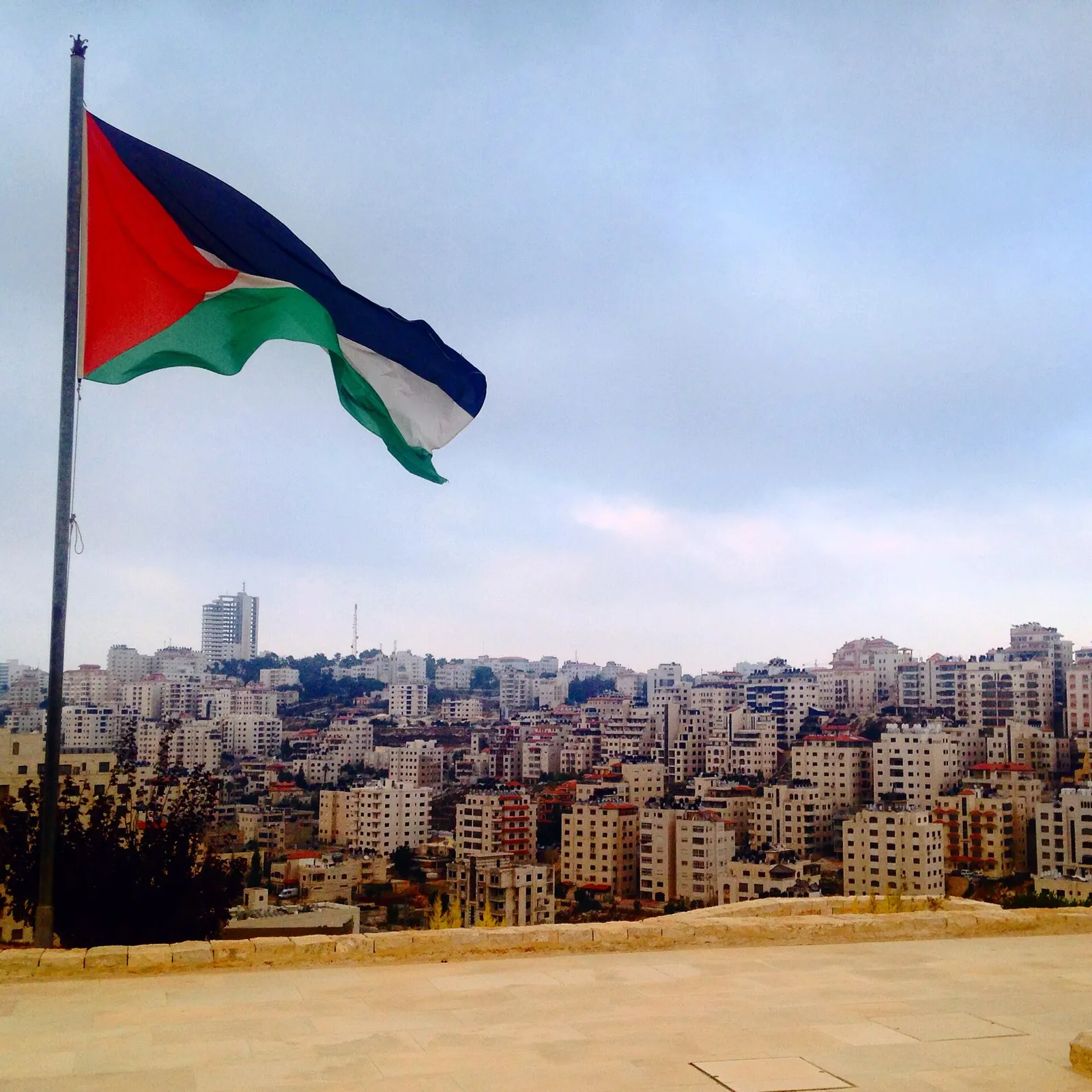A Palestinian flag above Ramallah, near where Sliman Mansour was born