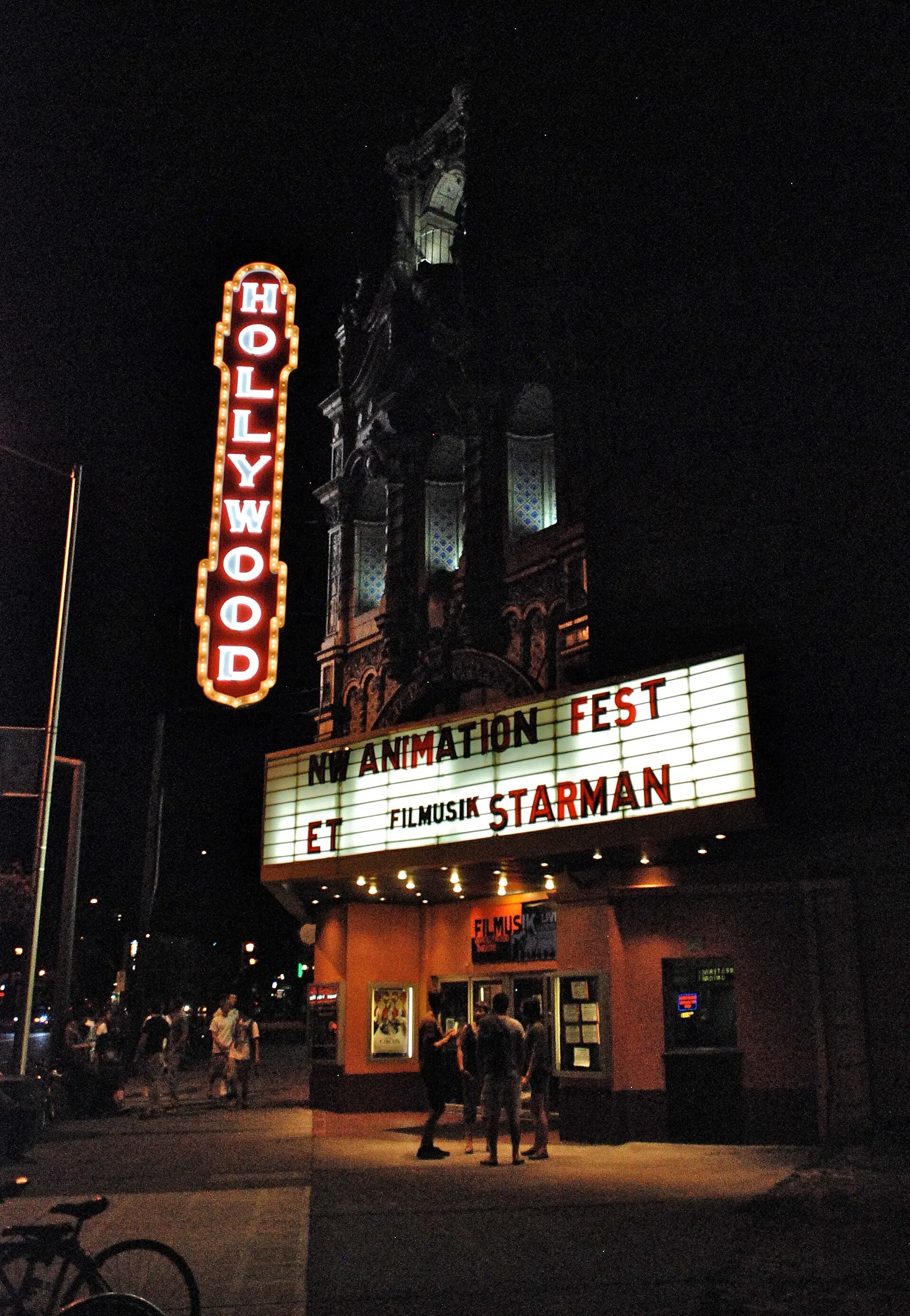 A movie theater lit up at night