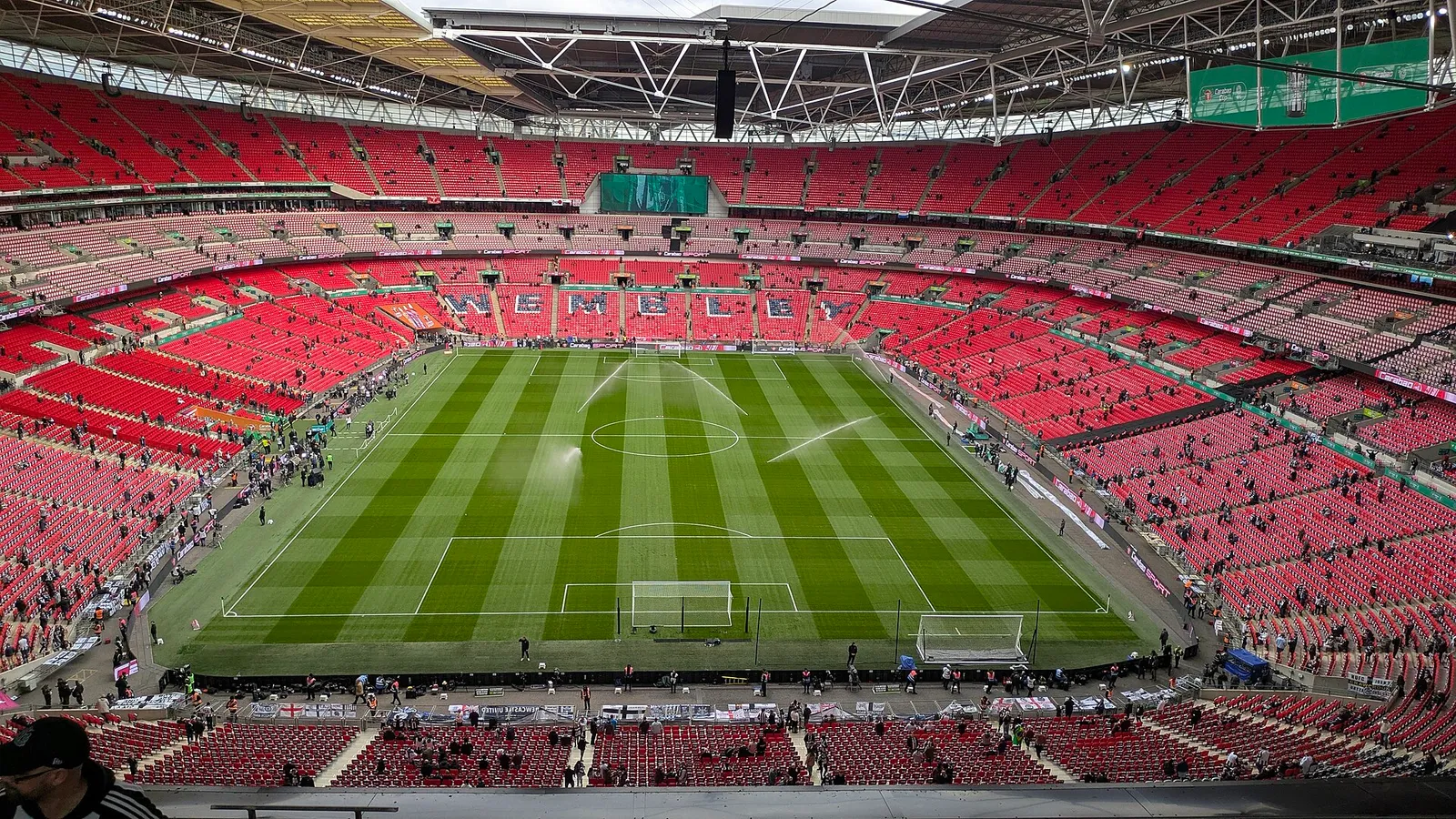 A football pitch inside a large stadium