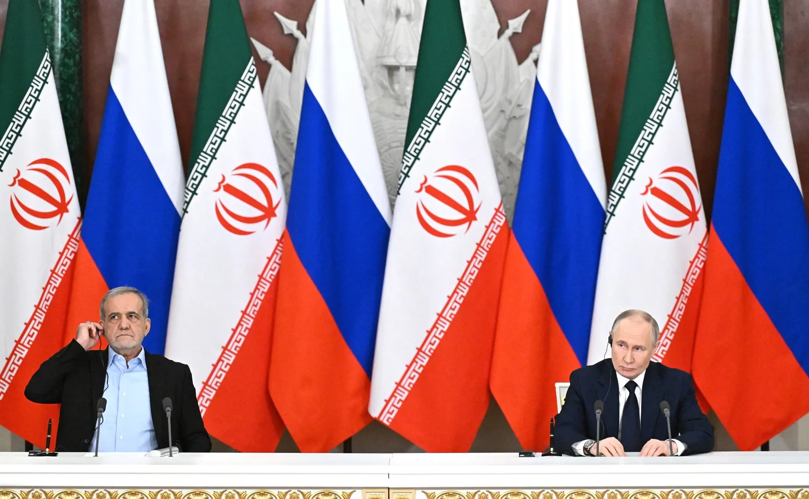 Iran's president Masoud Pezeshkian, left, at a press conference with Russia's president Vladimir Putin in Moscow