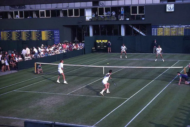 A tennis match in progress on an outside court