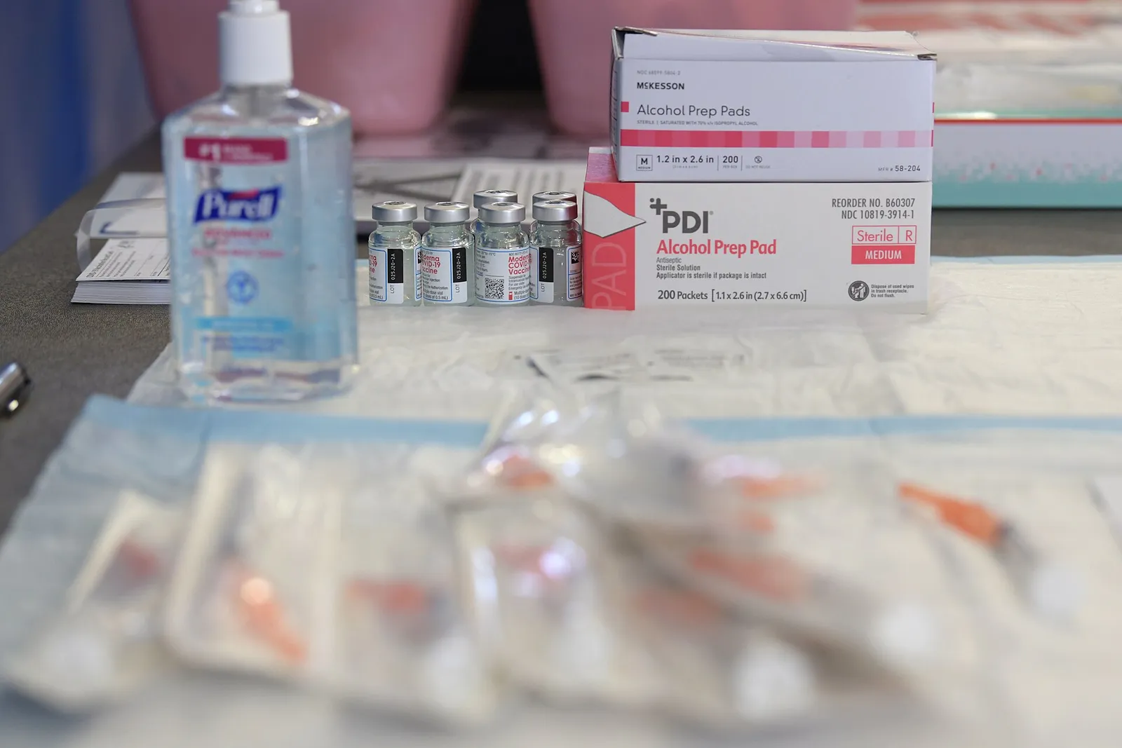 Vaccine vials and syringes prepared at a vaccination station