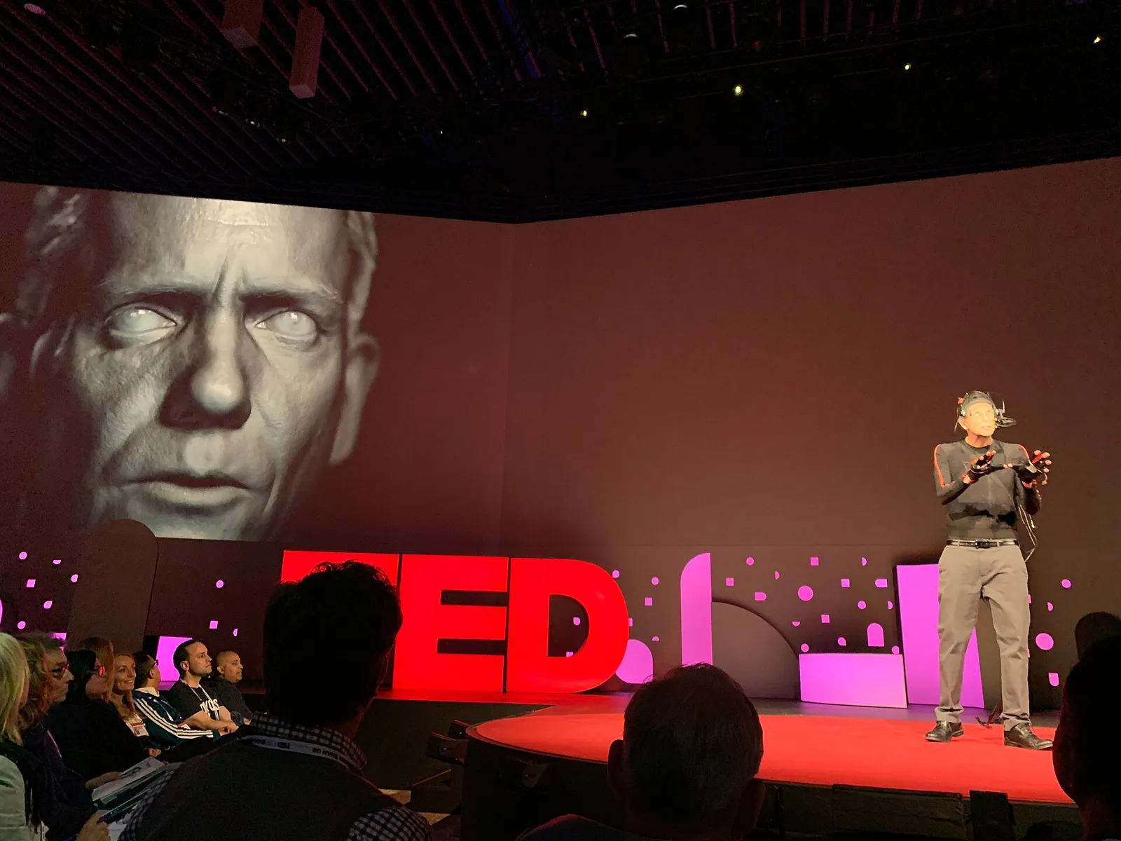 A digital, AI-generated human face demonstrated on screen (illustrative)