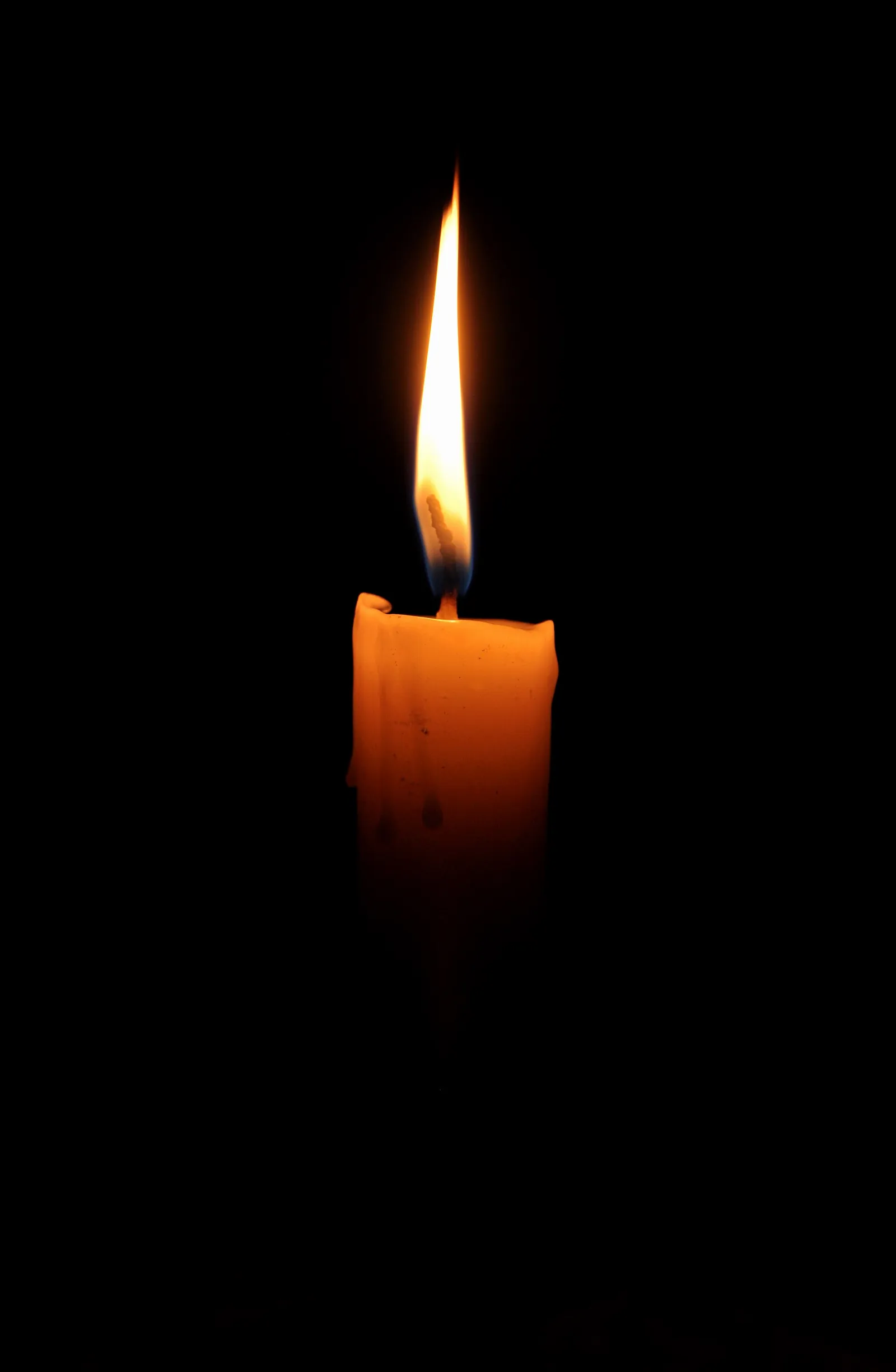 A single lit candle in the dark (file image)