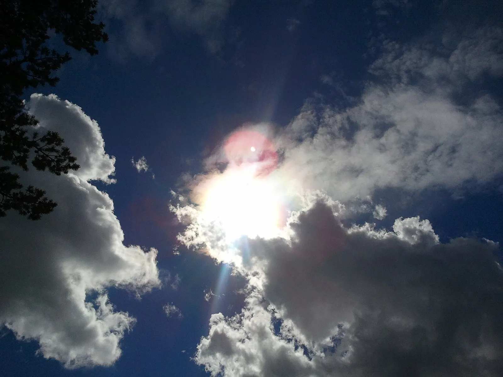 The sun in a partly cloudy sky