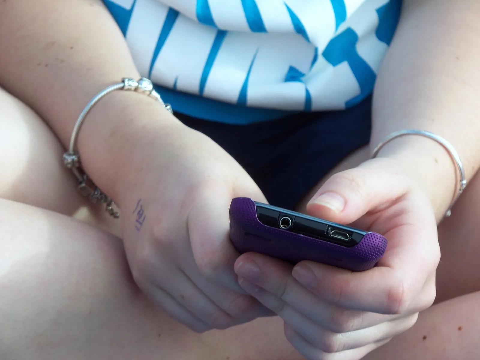A teenager using a smartphone (file image)