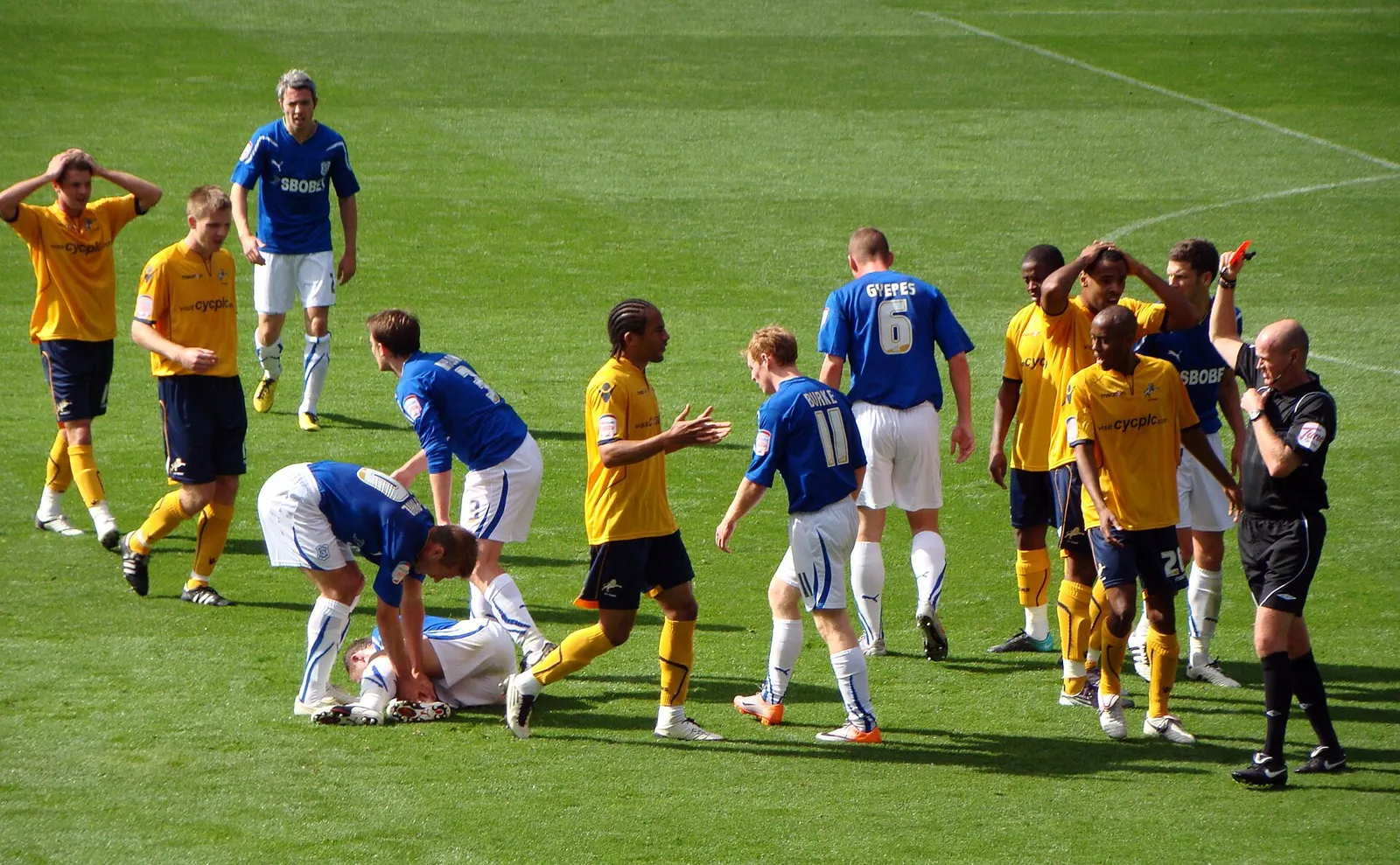 A referee shows a red card during a football match
