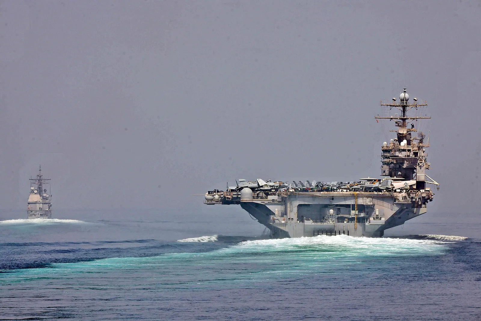 Naval vessels transit the Strait of Hormuz