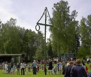A flower-decked midsummer maypole in Sweden
