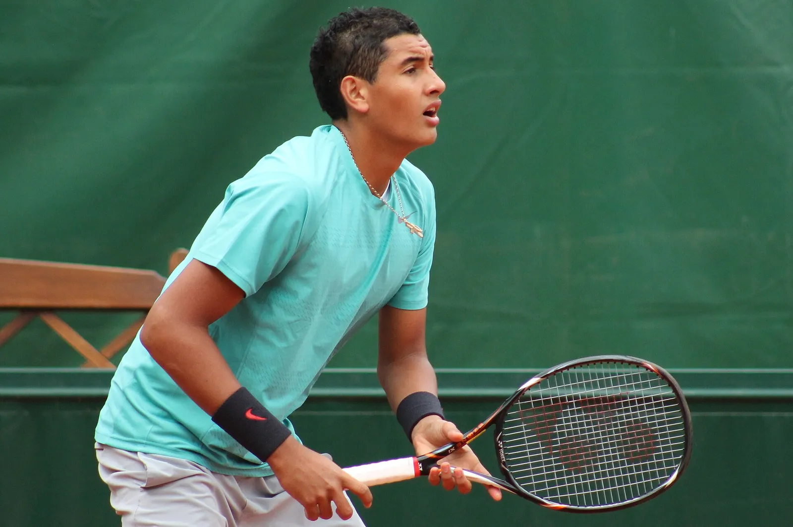 Nick Kyrgios hitting a backhand during a match