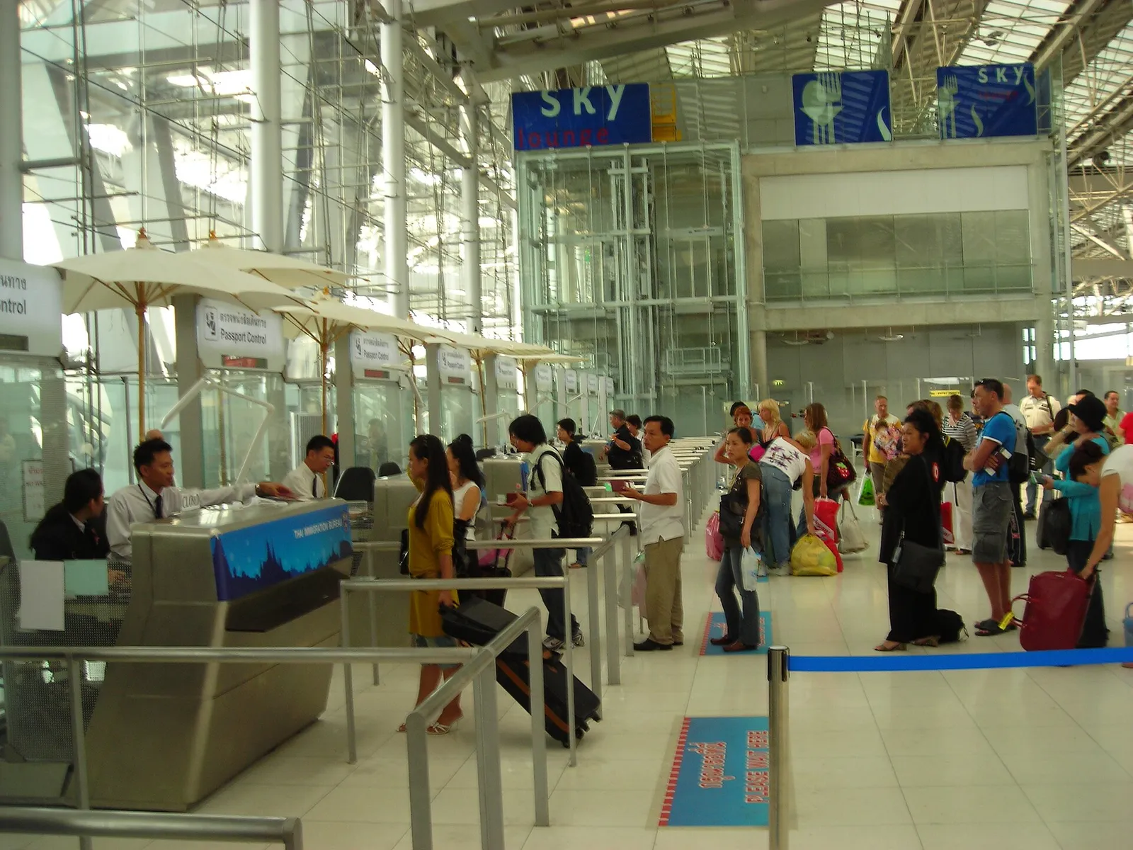 Travelers queuing at airport passport control