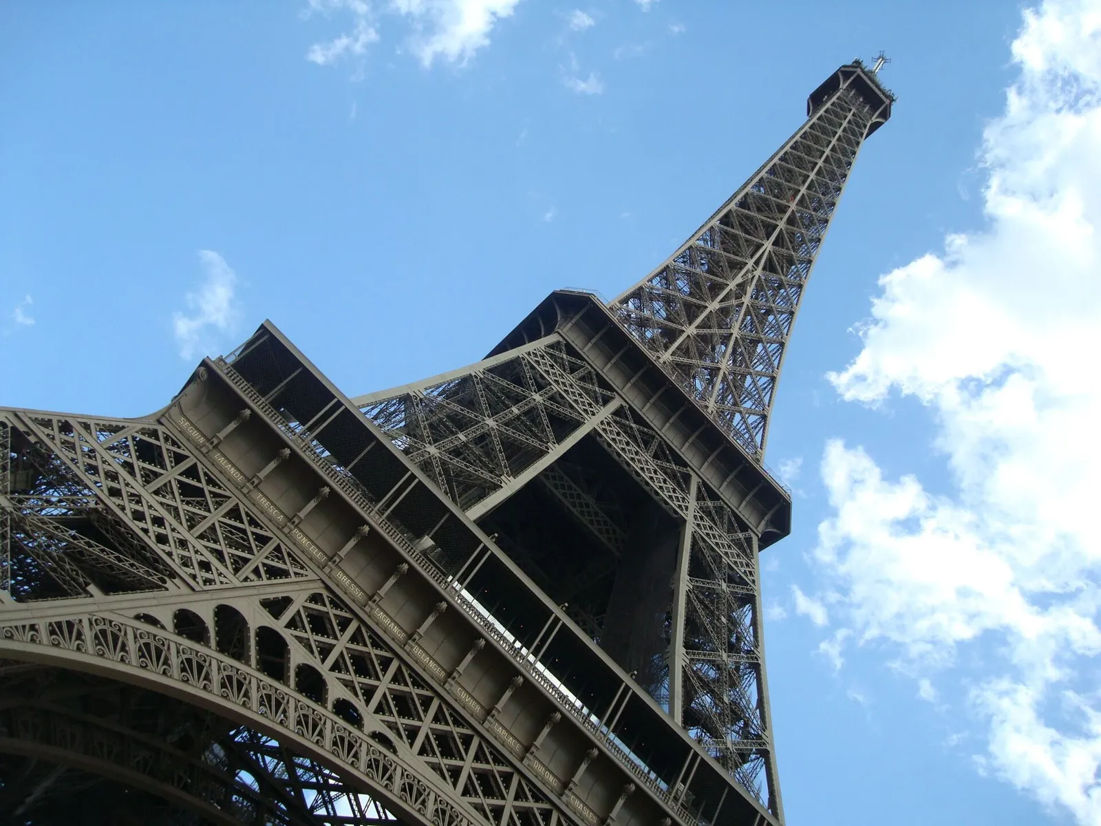The Eiffel Tower in Paris under a clear summer sky