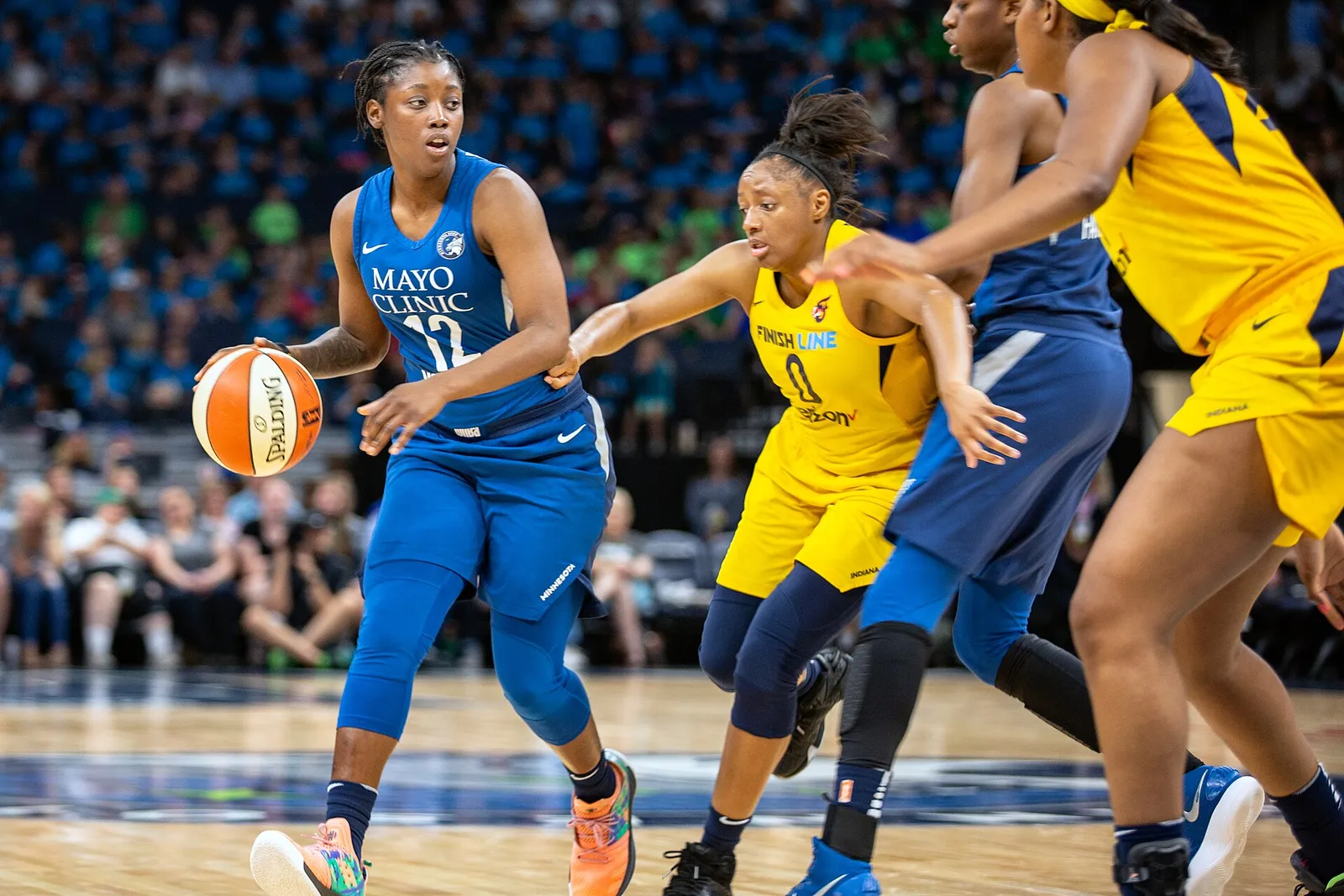 Kelsey Mitchell of the Indiana Fever defending during a game against the Minnesota Lynx