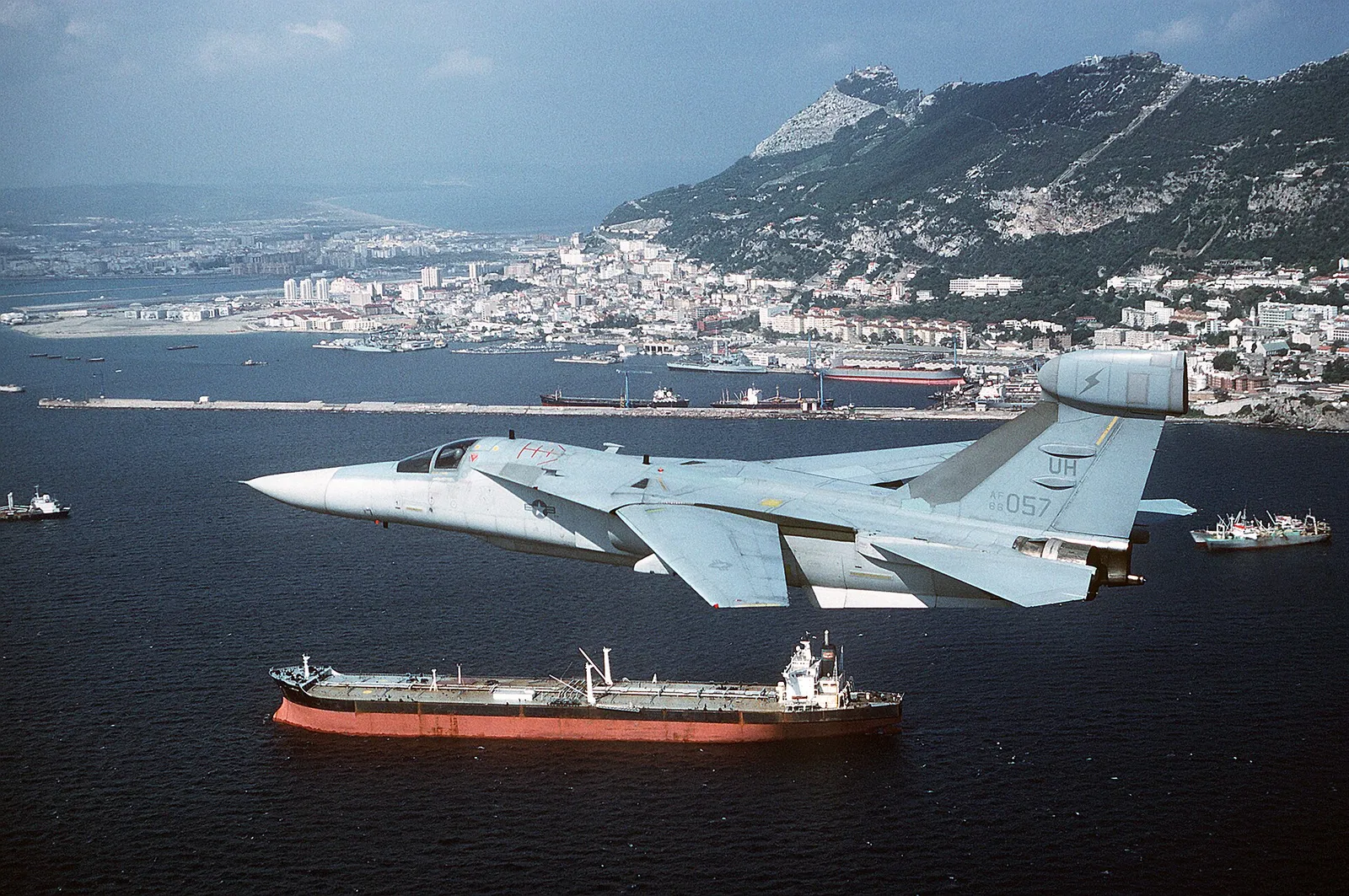 A military aircraft flies over an oil tanker at sea (file image)