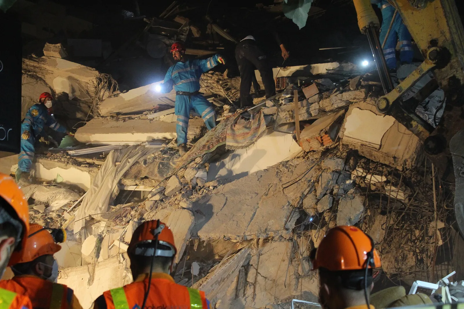 Search-and-rescue workers at a collapsed building after an earthquake