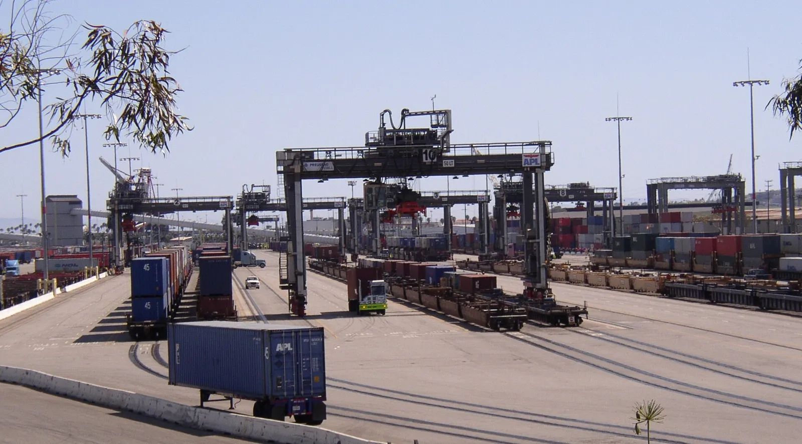 Containers being transferred between ship and rail at a port terminal