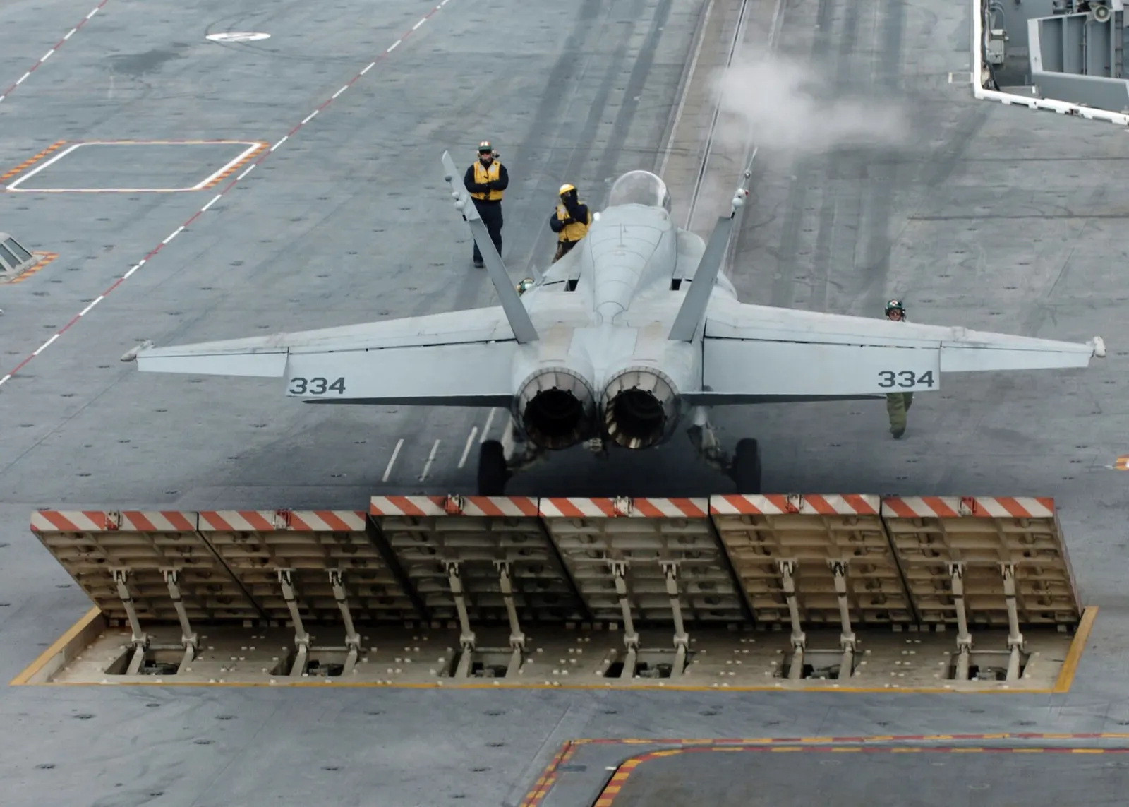 A US Navy fighter jet on an aircraft carrier flight deck (file image)