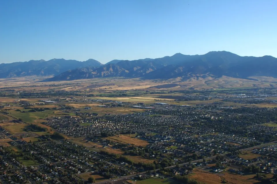 An aerial view of Bozeman, Montana, with the surrounding Gallatin Valley and mountains