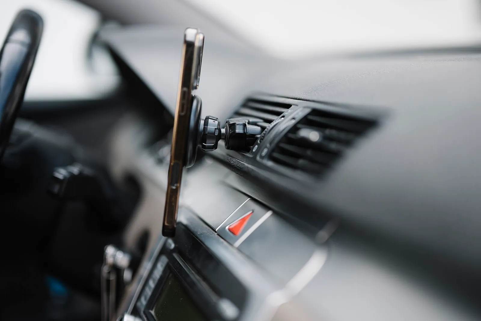 A smartphone mounted on a car dashboard (illustrative photograph)